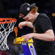 Apr 4, 2022; New Orleans, LA, USA; Kansas Jayhawks guard Chris Teahan (12) cuts a piece of the net after their win against the North Carolina Tar Heels in the 2022 NCAA men's basketball tournament Final Four championship game at Caesars Superdome. Bob Donnan-USA TODAY Sports